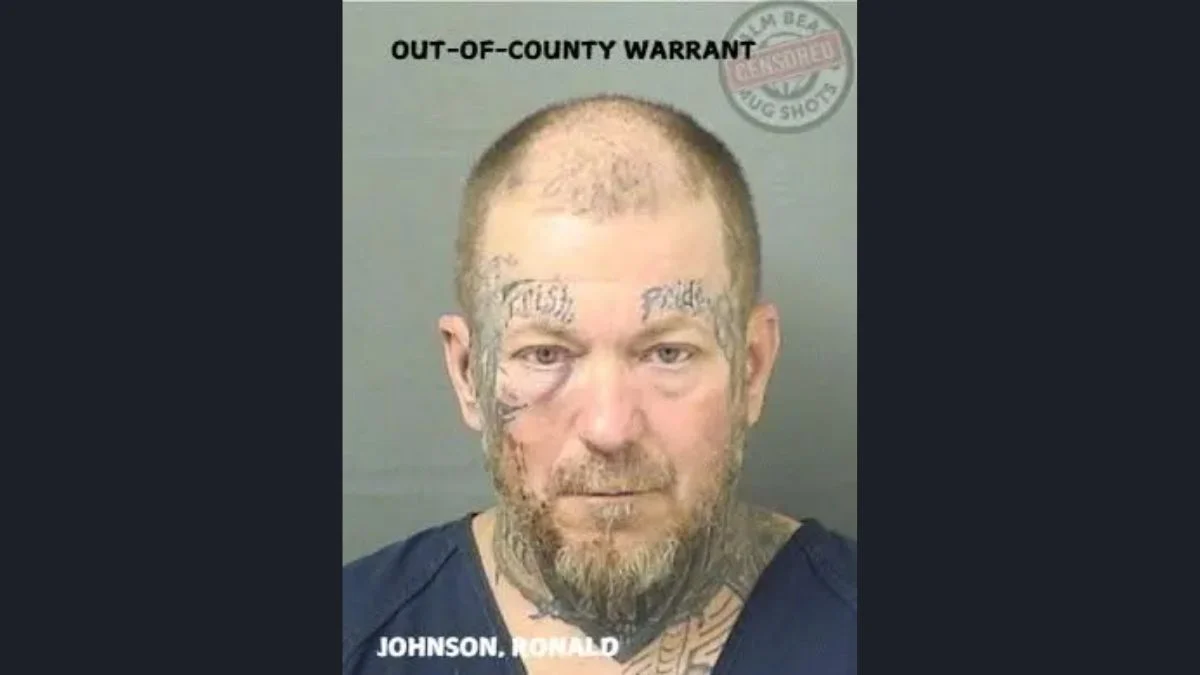 Booking mugshot of Ronald Jeffery Johnson displaying facial tattoos and an out-of-county warrant watermark.