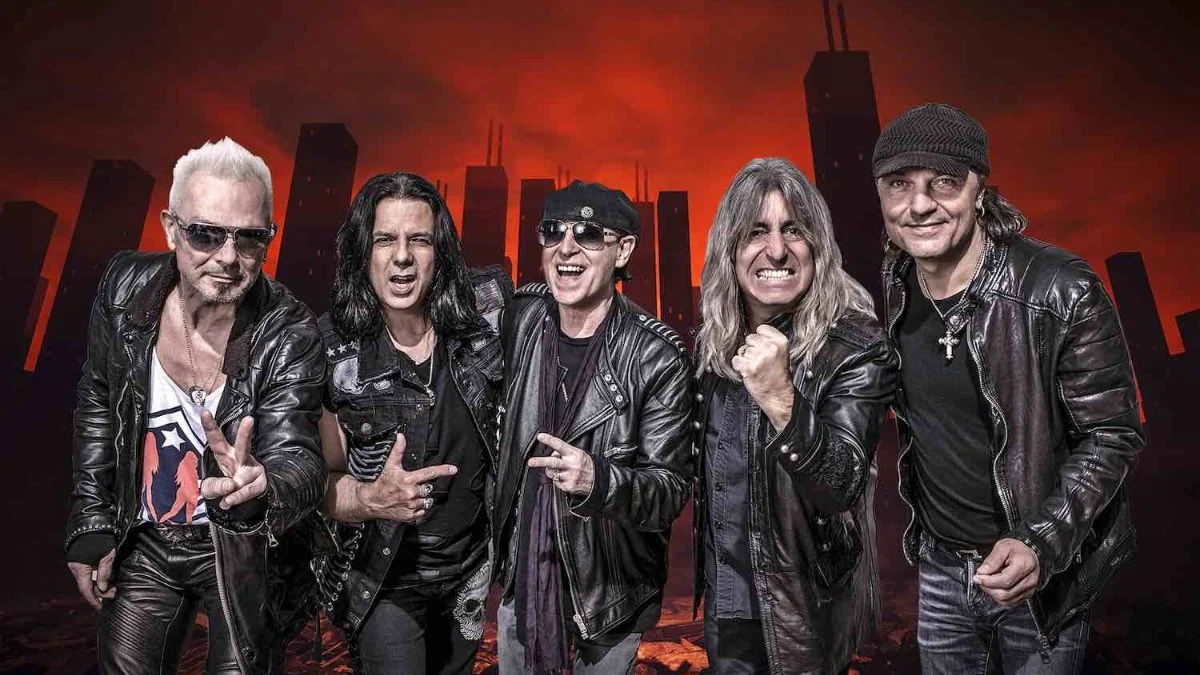Members of the rock band Scorpions posing together in front of a red sky and city skyline background.