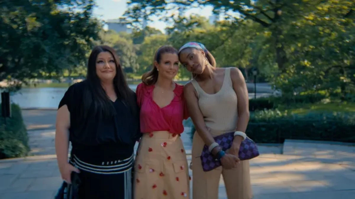 Sweet Magnolias cast members JoAnna Garcia Swisher, Brooke Elliott, and Heather Headley standing together outdoors