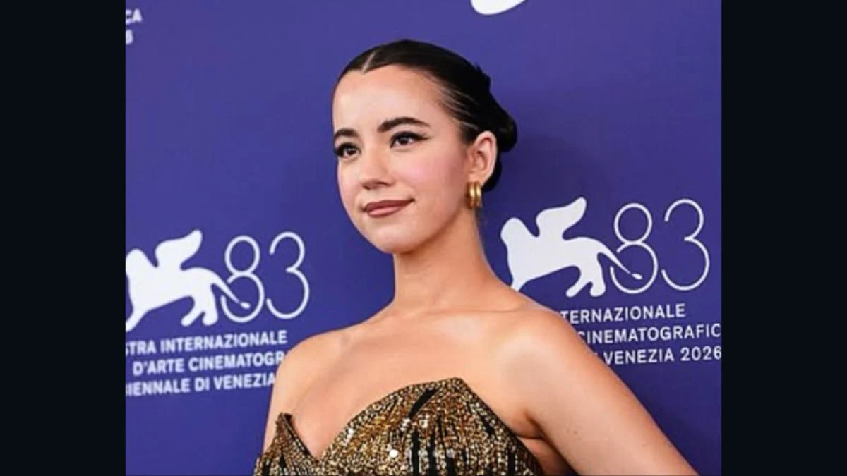 Former conservative influencer Ashley St. Clair wearing a patterned metallic dress at the Venice International Film Festival backdrop.
