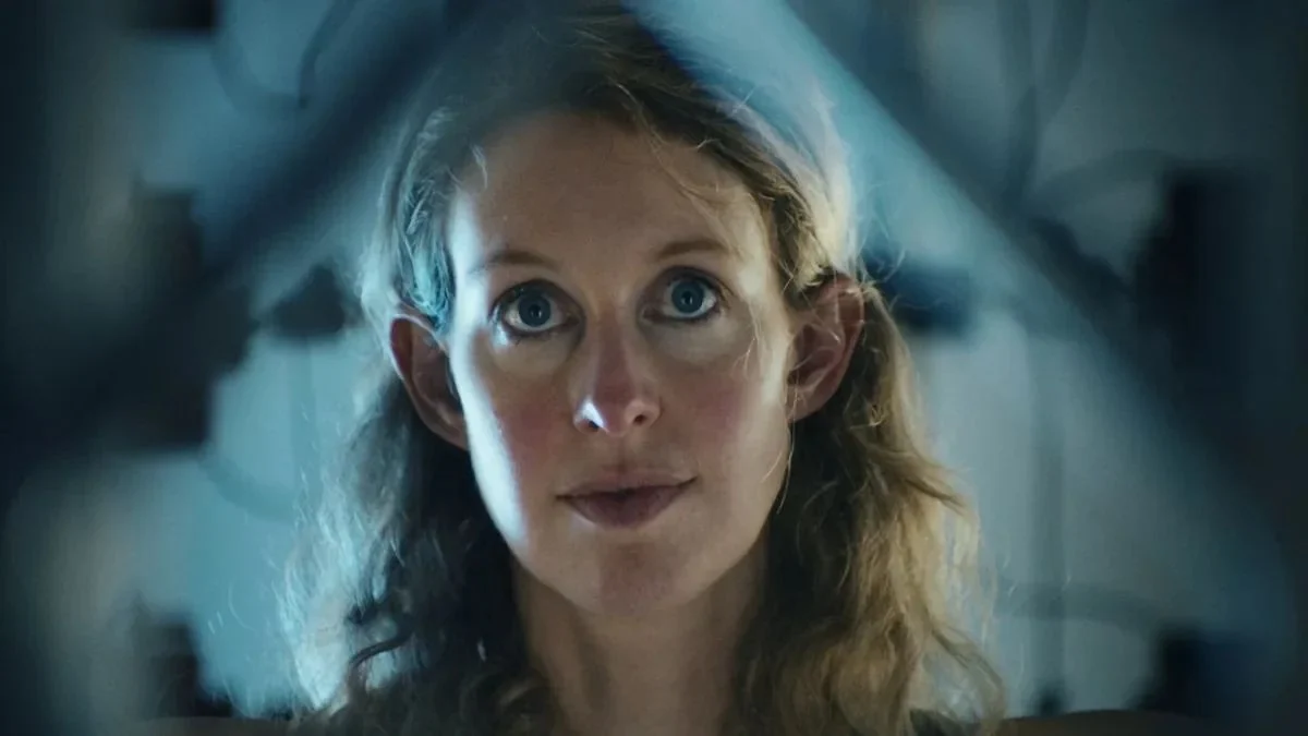 Close-up frame of Elizabeth Holmes looking directly into the camera in A24's You Can See Everything documentary