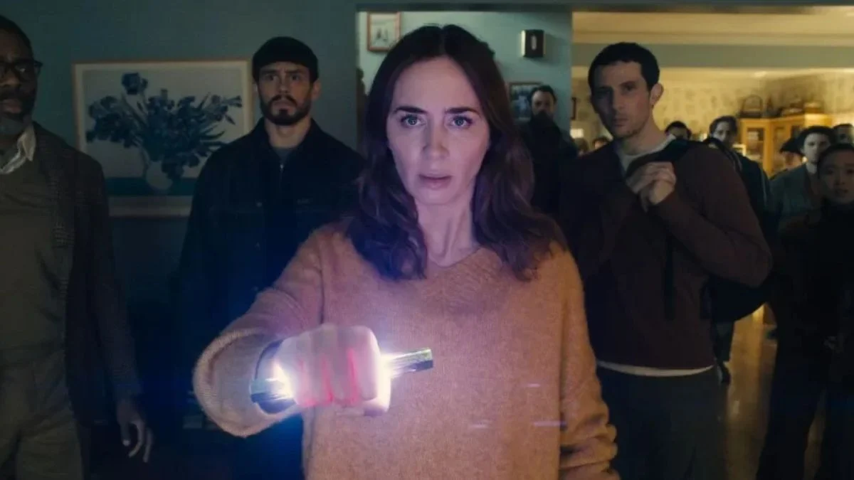 Emily Blunt holding a glowing device surrounded by onlookers in Disclosure Day