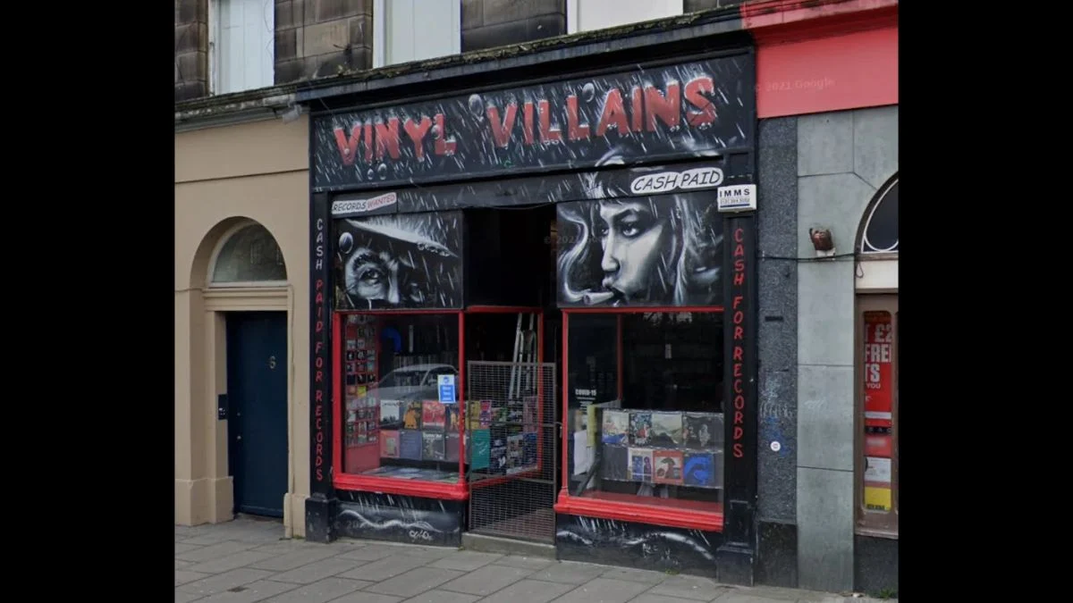 Front storefront view of Vinyl Villains record shop located at 5 Elm Row in Edinburgh with painted signage