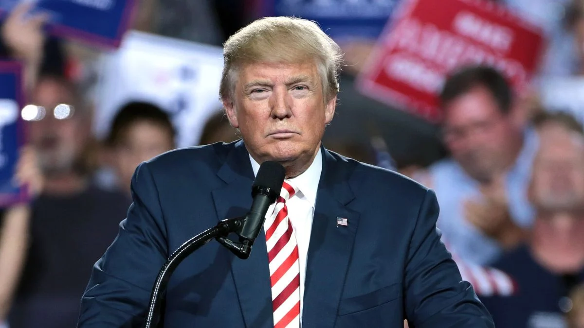 Donald Trump speaking at a microphone during a public address.