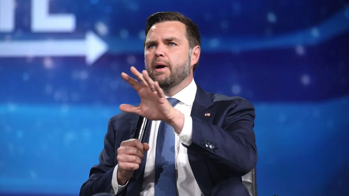 Vice President JD Vance speaking passionately with hand gestures during a panel event.