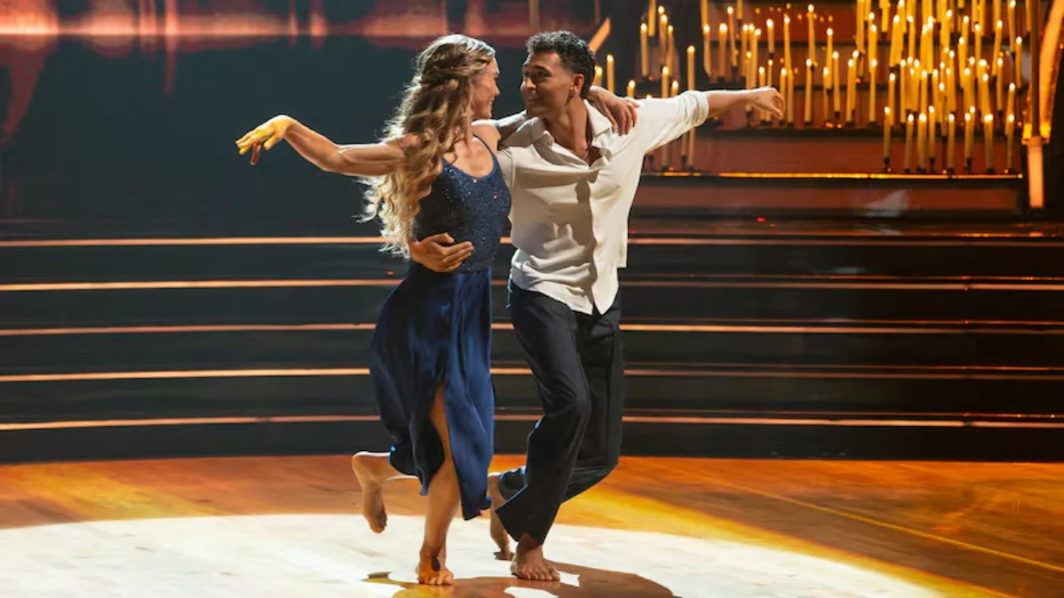Julia Stiles in a blue dress dancing barefoot with pro partner Ezra Sosa during DWTS Dedication Night