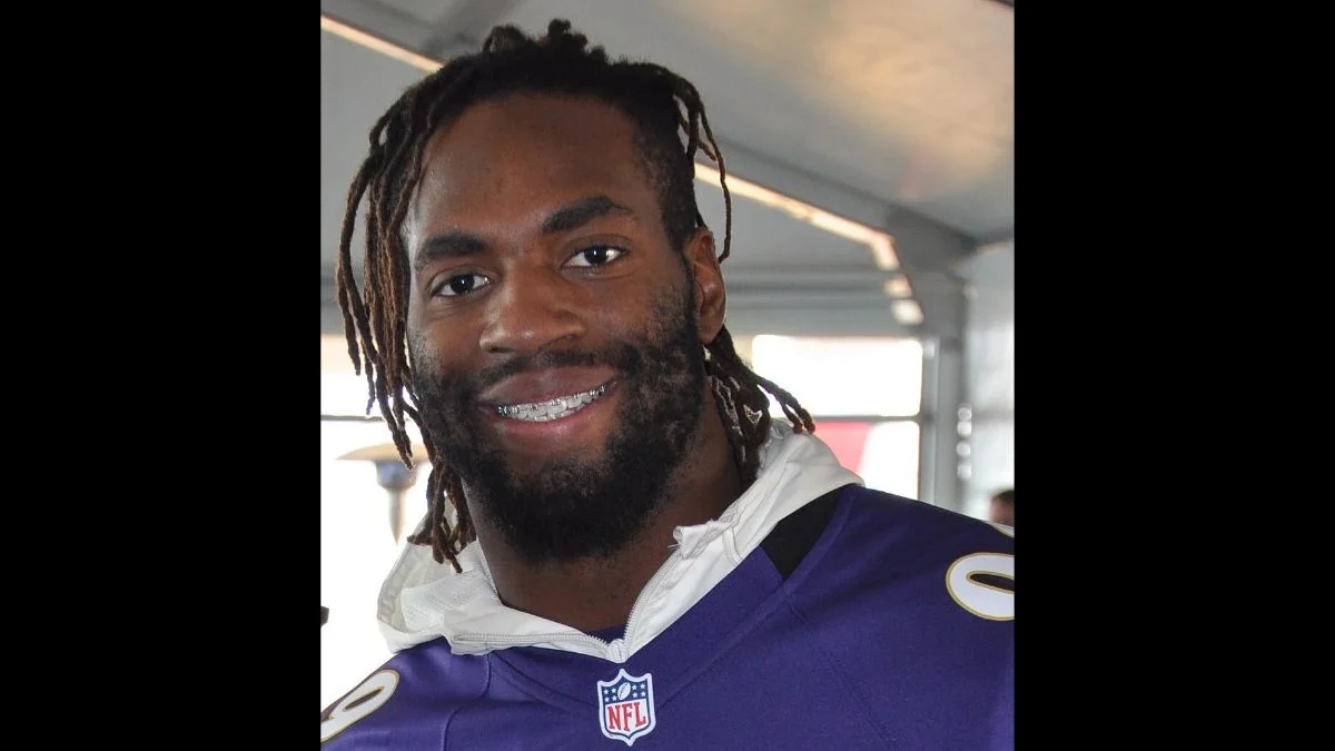 NFL linebacker Matthew Judon smiling in a purple Baltimore Ravens jersey
