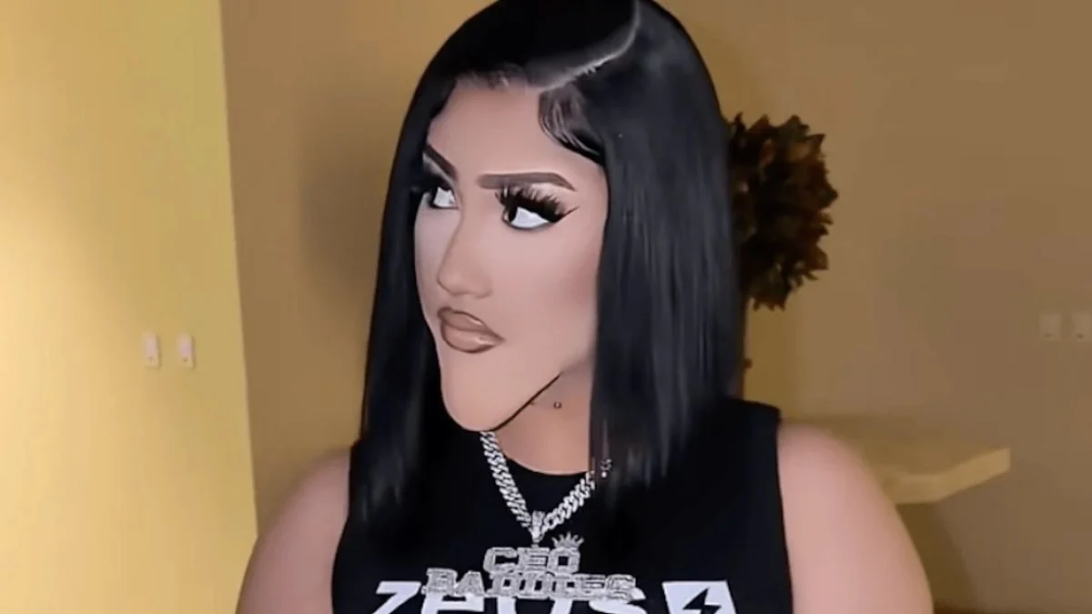 North West dressed as Natalie Nunn with a prosthetic chin, black bob wig, and CEO Baddies chain