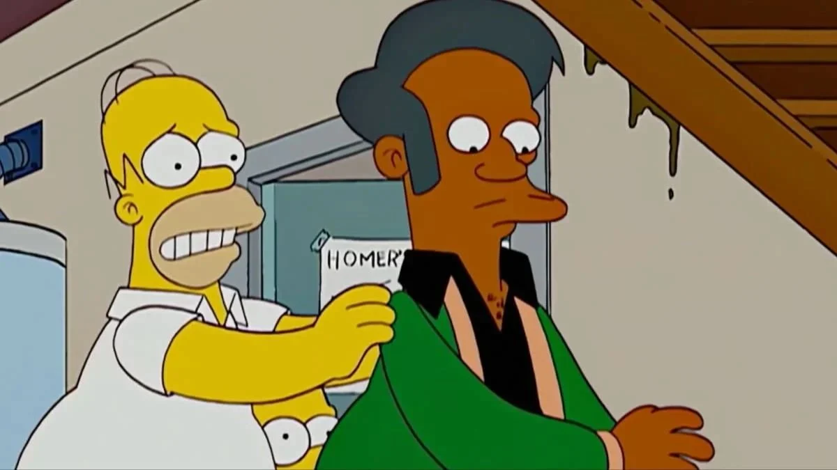 Homer Simpson standing behind Apu Nahasapeemapetilon looking worried in a scene from The Simpsons