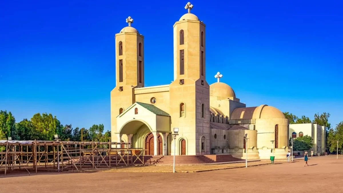 Exterior view of an Ethiopian Orthodox Church building with twin bell towers and crosses
