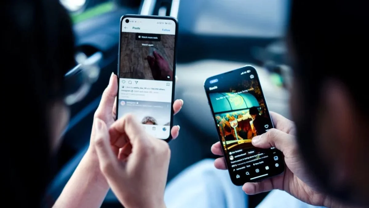 Two people holding smartphones displaying Instagram Reels feeds