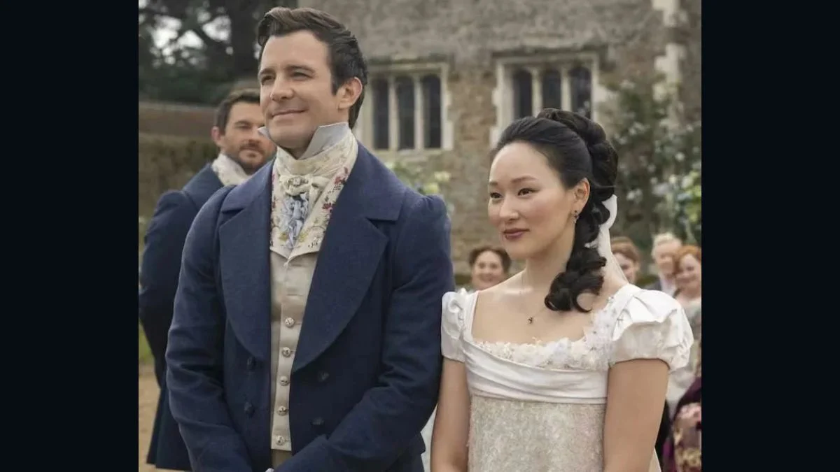 Luke Thompson as Benedict Bridgerton and Yerin Ha as Sophie Baek standing together during a wedding scene in Bridgerton